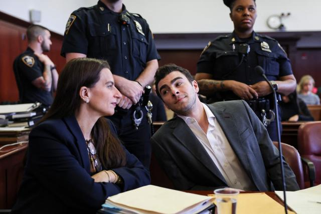 Luigi Mangione appears in Manhattan Supreme Court alongside his attorney Karen Friedman Agnifilo (L) during an evidentiary hearing in the murder case of UnitedHealthcare CEO Brian Thompson on December 4, 2025 in New York City. (Photo by ANGELA WEISS / POOL / AFP)