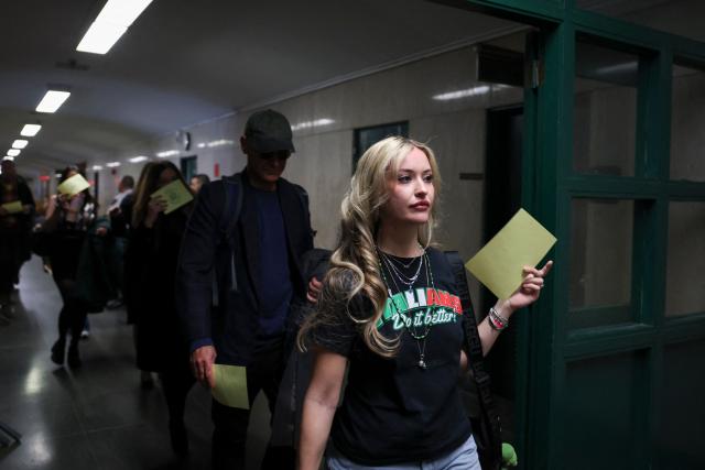 Supporters of Luigi Mangione arrive at Manhattan Supreme Court to attend an evidentiary hearing in the murder case of UnitedHealthcare CEO Brian Thompson, in New York, on December 4, 2025. (Photo by ANGELA WEISS / AFP)