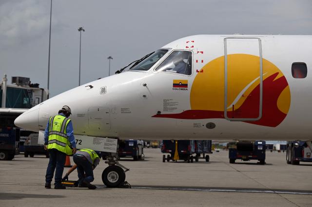 (FILES) A Satena Airlines aircraft covering the route Bogota-Caracas is pictured upon arrival at Simon Bolivar International Airport in Maiquetia, La Guaira State, Venezuela, on November 9, 2022. Colombian state-owned airline Satena announced the suspension of flights to Venezuela on December 4, 2025, due to “interference” in navigation systems, amid US bombings in the Caribbean and threats of a ground offensive. (Photo by Federico PARRA / AFP)