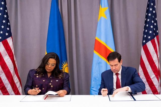 US Secretary of State Marco Rubio (R) and the Foreign Minister of the Democratic Republic of the Congo Therese Kayikwamba Wagner sign agreements during a ceremony at the US Institute of Peace in Washington, DC on December 4, 2025. US President Donald Trump on Thursday brings the leaders of Rwanda and the Democratic Republic of Congo together to endorse a deal that Trump has hailed as his latest peace triumph despite ongoing violence on the ground. Trump hopes the agreement will pave the way for the United States to gain access to critical minerals in the eastern DRC, a violence-torn region home to many of the key ingredients in modern technologies such as electric cars. (Photo by Allison ROBBERT / AFP)