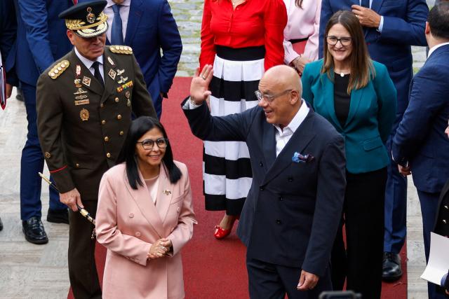 Venezuela's Vice President Delcy Rodriguez (C-L) and National Assembly President Jorge Rodriguez (C-R) arrive for the presentation of the 2026 fiscal year budget at the National Congress in Caracas on December 4, 2025. (Photo by Pedro MATTEY / AFP)