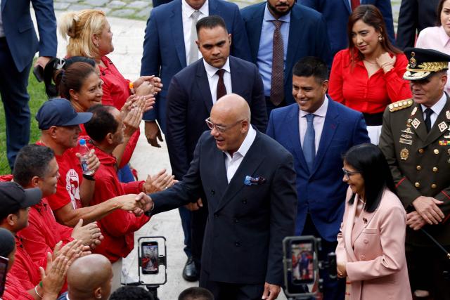 Venezuela's National Assembly President Jorge Rodriguez (C) and Vice President Delcy Rodriguez (R) arrive for the presentation of the 2026 fiscal year budget at the National Congress in Caracas on December 4, 2025. (Photo by Pedro MATTEY / AFP)