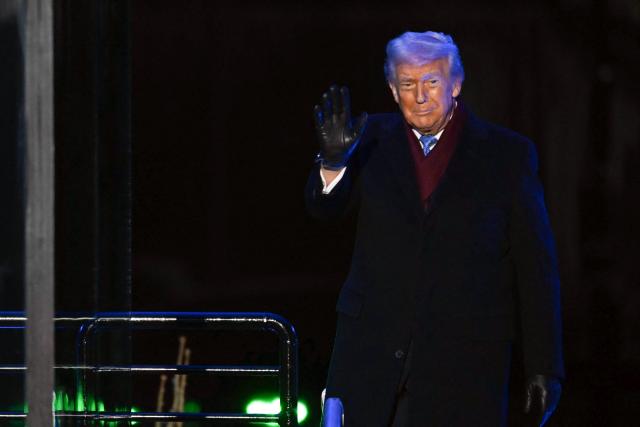 US President Donald Trump waves to the crowd during the National Christmas Tree Lighting at the Ellipse in Washington, DC, on December 4, 2025. (Photo by ANDREW CABALLERO-REYNOLDS / AFP)