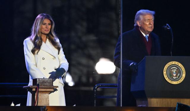 First Lady Melania Trump listes to US President Donald Trump speak at the National Christmas Tree Lighting at the Ellipse in Washington, DC, on December 4, 2025. (Photo by Alex WROBLEWSKI / AFP)