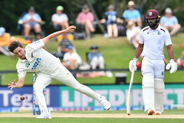 New Zealand's Zak Foulkes (L) fields the ball next to West Indies' John Campbell during day four of the first Test cricket match between New Zealand and West Indies at Hagley Oval in Christchurch on December 5, 2025. (Photo by Sanka Vidanagama / AFP)