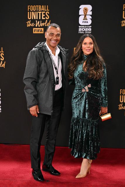 Brazilian former football player Cafu (L) and his partner Mariah Morais arrive for the pre-draw reception for the 2026 FIFA Football World Cup taking place in the US, Canada and Mexico, at the Kennedy Center, in Washington, DC, on December 4, 2025. (Photo by Roberto SCHMIDT / AFP)