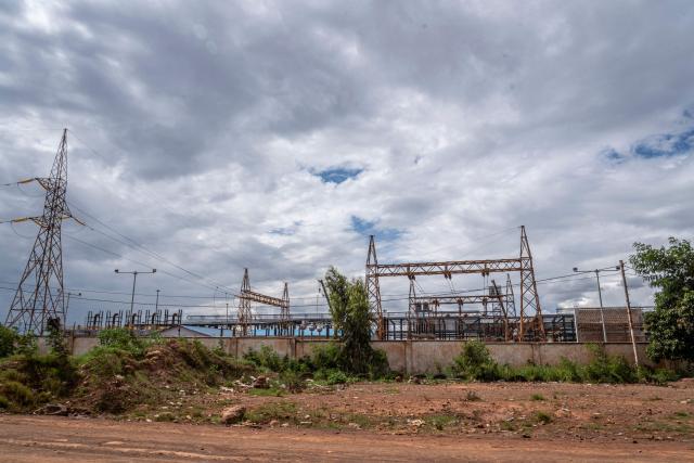 A general view of a power plant in Lubumbashi on November 24, 2025. Her parched field is overrun with debris carried by polluted waters, and the little girl in his arms is covered in sores: in Lubumbashi, the mining capital of the DRC, thousands of Congolese claim to be victims of toxic waste from the mining industry. Hélène Mvubu recounts enduring for years the effects of floods caused by contaminated water discharged by Congo Dongfang Mining (CDM), a Chinese mining company that processes copper and cobalt ores in the outskirts of the capital of Katanga province, in the southeastern Democratic Republic of Congo (DRC). (Photo by Glody MURHABAZI / AFP)