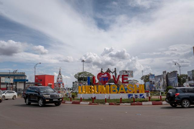 A general view of the Katangaise Unity monument at a roundabout in Lubumbashi on November 24, 2025. Her parched field is overrun with debris carried by polluted waters, and the little girl in his arms is covered in sores: in Lubumbashi, the mining capital of the DRC, thousands of Congolese claim to be victims of toxic waste from the mining industry. Hélène Mvubu recounts enduring for years the effects of floods caused by contaminated water discharged by Congo Dongfang Mining (CDM), a Chinese mining company that processes copper and cobalt ores in the outskirts of the capital of Katanga province, in the southeastern Democratic Republic of Congo (DRC). (Photo by Glody MURHABAZI / AFP)