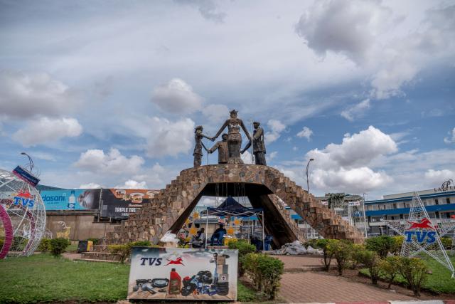 A general view of the Katangaise Unity monument at a roundabout in Lubumbashi on November 24, 2025. Her parched field is overrun with debris carried by polluted waters, and the little girl in his arms is covered in sores: in Lubumbashi, the mining capital of the DRC, thousands of Congolese claim to be victims of toxic waste from the mining industry. Hélène Mvubu recounts enduring for years the effects of floods caused by contaminated water discharged by Congo Dongfang Mining (CDM), a Chinese mining company that processes copper and cobalt ores in the outskirts of the capital of Katanga province, in the southeastern Democratic Republic of Congo (DRC). (Photo by Glody MURHABAZI / AFP)
