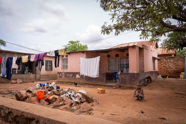 Hortance Kiluba (C) hand wash clotes at home in the Kamitete district of Lubumbashi on November 24, 2025. Her parched field is overrun with debris carried by polluted waters, and the little girl in his arms is covered in sores: in Lubumbashi, the mining capital of the DRC, thousands of Congolese claim to be victims of toxic waste from the mining industry. Hélène Mvubu recounts enduring for years the effects of floods caused by contaminated water discharged by Congo Dongfang Mining (CDM), a Chinese mining company that processes copper and cobalt ores in the outskirts of the capital of Katanga province, in the southeastern Democratic Republic of Congo (DRC). (Photo by Glody MURHABAZI / AFP)