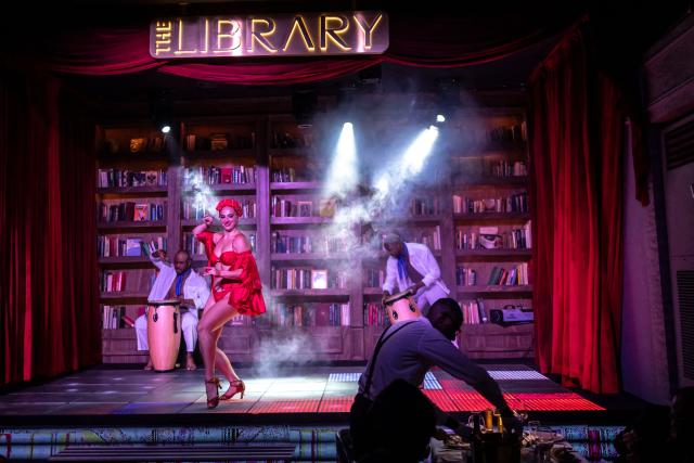 (FILES) A dancer performs on stage as patrons sit at tables inside The Library restaurant and club in Lagos, on September 6, 2025. Scantily clad in a sequin leotard and silver heels, the dancer swayed to "Money" by Cardi B in a mega-sized cocktail glass.
Nigeria might be going through its worst economic crisis in a generation, but in Lagos, the party hasn't stopped.
Patrons at The Library, where fake banknotes rained down on the stage, were being treated to both dinner and a show as cabaret takes the mega-city by storm.
Clubs like The Library have been fully revamped to cash in on the trend, tapping into the best singers and dancers across the African cultural powerhouse, but also drawing talent from across the world. (Photo by OLYMPIA DE MAISMONT / AFP)