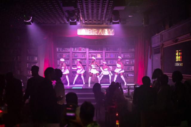 (FILES) Dancers perform on stage inside The Library restaurant and club in Lagos, on September 7, 2025. Scantily clad in a sequin leotard and silver heels, the dancer swayed to "Money" by Cardi B in a mega-sized cocktail glass.
Nigeria might be going through its worst economic crisis in a generation, but in Lagos, the party hasn't stopped.
Patrons at The Library, where fake banknotes rained down on the stage, were being treated to both dinner and a show as cabaret takes the mega-city by storm.
Clubs like The Library have been fully revamped to cash in on the trend, tapping into the best singers and dancers across the African cultural powerhouse, but also drawing talent from across the world. (Photo by OLYMPIA DE MAISMONT / AFP)