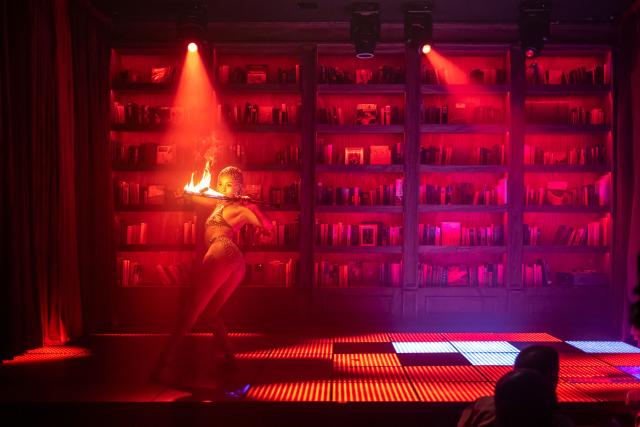 (FILES) A dancer performs holding fire torches on stage inside The Library restaurant and club in Lagos, on September 7, 2025. Scantily clad in a sequin leotard and silver heels, the dancer swayed to "Money" by Cardi B in a mega-sized cocktail glass.
Nigeria might be going through its worst economic crisis in a generation, but in Lagos, the party hasn't stopped.
Patrons at The Library, where fake banknotes rained down on the stage, were being treated to both dinner and a show as cabaret takes the mega-city by storm.
Clubs like The Library have been fully revamped to cash in on the trend, tapping into the best singers and dancers across the African cultural powerhouse, but also drawing talent from across the world. (Photo by OLYMPIA DE MAISMONT / AFP)