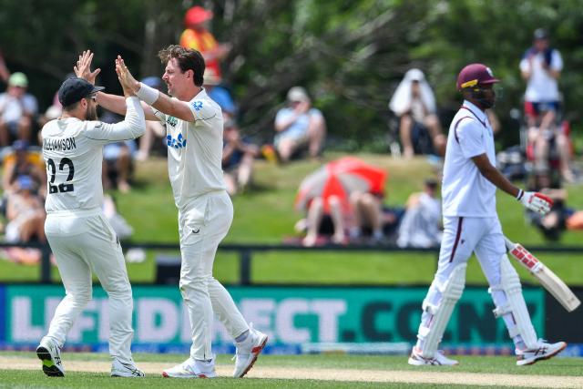 New Zealand's Matt Henry (C) and Kane Williamson celebrate the dismissal of West Indies' Roston Chase (R) during day four of the first Test cricket match between New Zealand and West Indies at Hagley Oval in Christchurch on December 5, 2025. (Photo by Sanka Vidanagama / AFP)