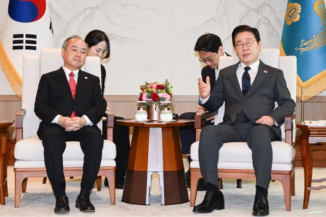 South Korea's President Lee Jae Myung (R) meets with Chairman and CEO of SoftBank Masayoshi Son (L) at the Presidential House in Seoul on December 5, 2025. (Photo by KIM Min-Hee / POOL / AFP)