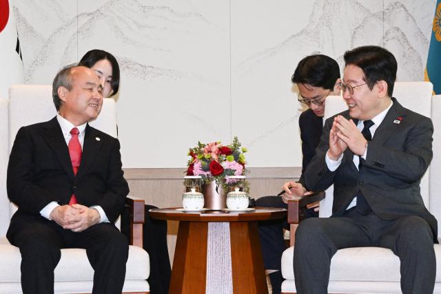 South Korea's President Lee Jae Myung (R) meets with Chairman and CEO of SoftBank Masayoshi Son (L) at the Presidential House in Seoul on December 5, 2025. (Photo by KIM Min-Hee / POOL / AFP)