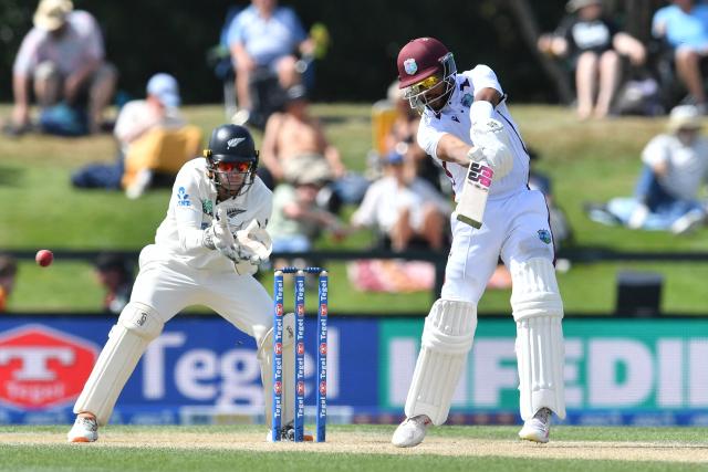 West Indies' Shai Hope (R) plays a shot in front of New Zealand's wicketkeeper Tom Latham during day four of the first Test cricket match between New Zealand and West Indies at Hagley Oval in Christchurch on December 5, 2025. (Photo by Sanka Vidanagama / AFP)