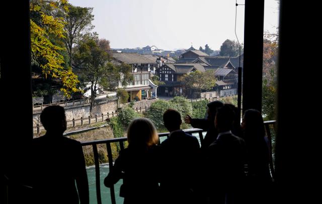 French President Emmanuel Macron, his wife Brigitte Macron, Chinese President Xi Jinping and his wife Peng Liyuan visit the Dujiangyan site, a designated UNESCO World Heritage site, in Dujiangyan, in southwestern China's Sichuan province on December 5, 2025. (Photo by Sarah Meyssonnier / POOL / AFP)