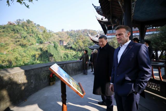 Chinese President Xi Jinping (2nd R) and French President Emmanuel Macron visit the Dujiangyan site, a designated UNESCO World Heritage site, in Dujiangyan, in southwestern China's Sichuan province on December 5, 2025. (Photo by Sarah Meyssonnier / POOL / AFP)