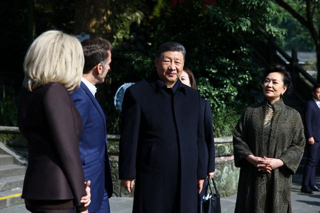 French President Emmanuel Macron (2nd L), his wife Brigitte Macron (L), Chinese President Xi Jinping (2nd R) and his wife Peng Liyuan visit the Dujiangyan site, a designated UNESCO World Heritage site, in Dujiangyan, in southwestern China's Sichuan province on December 5, 2025. (Photo by Sarah Meyssonnier / POOL / AFP)