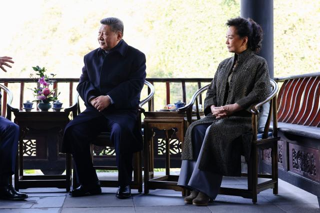 Chinese President Xi Jinping (L) and his wife Peng Liyuan (R) speak with French President Emmanuel Macron his wife Brigitte Macron during a visit at the Dujiangyan site, a designated UNESCO World Heritage site, in Dujiangyan, in southwestern China's Sichuan province on December 5, 2025. (Photo by Sarah Meyssonnier / POOL / AFP)