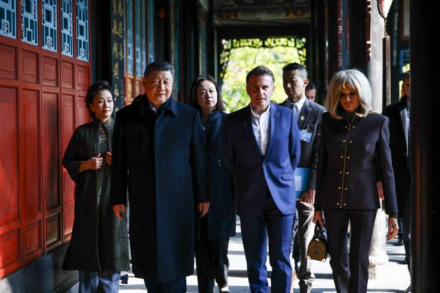 French President Emmanuel Macron (2nd R), his wife Brigitte Macron (R), Chinese President Xi Jinping (2nd L) and his wife Peng Liyuan (L) visit the Dujiangyan site, a designated UNESCO World Heritage site, in Dujiangyan, in southwestern China's Sichuan province on December 5, 2025. (Photo by Sarah Meyssonnier / POOL / AFP)