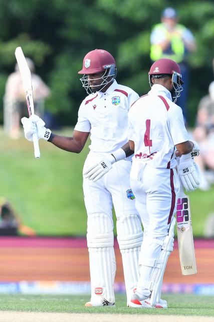 West Indies' Justin Greaves (L) celebrates his half century during day four of the first Test cricket match between New Zealand and West Indies at Hagley Oval in Christchurch on December 5, 2025. (Photo by Sanka Vidanagama / AFP)