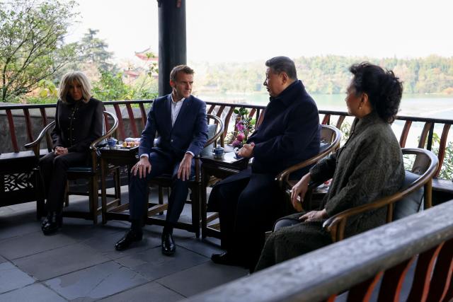 French President Emmanuel Macron (2nd L), his wife Brigitte Macron (L), Chinese President Xi Jinping (2nd R) and his wife Peng Liyuan visit the Dujiangyan site, a designated UNESCO World Heritage site, in Dujiangyan, in southwestern China's Sichuan province on December 5, 2025. (Photo by Sarah Meyssonnier / POOL / AFP)