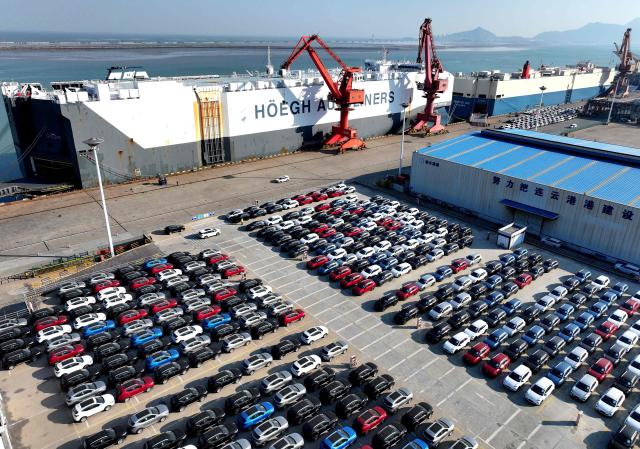 Cars for export wait to be shipped at a port in Lianyungang, eastern China's Jiangsu province on December 4, 2025. (Photo by AFP) / China OUT