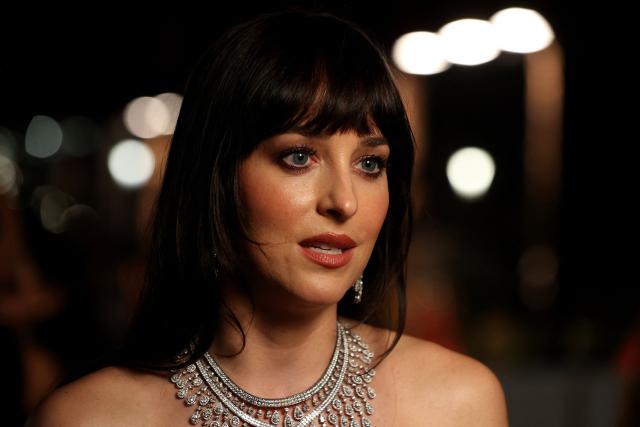 US actress Dakota Johnson arrives during the opening ceremony of the 5th edition of the Red Sea Film Festival in Jeddah on December 4, 2025. (Photo by Patrick BAZ / Factstory for the Red Sea International Festival (RSFF) / AFP)