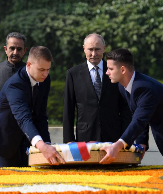 In this pool photograph distributed by the Russian state agency Sputnik, Russia's President Vladimir Putin pays his respect at the Mahatma Gandhi memorial at Rajghat in New Delhi on December 5, 2025. India's Prime Minister Narendra Modi hosts Russia's President Vladimir Putin at a summit on December 5, with defence and trade ties centre stage as New Delhi faces heavy US pressure to stop buying Moscow's oil. (Photo by Grigory SYSOYEV / POOL / AFP) / ***Editor's note : this image is distributed by the Russian state owned agency Sputnik***