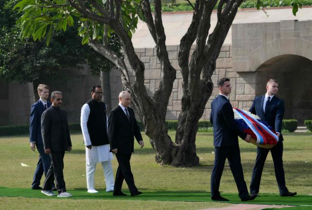 In this pool photograph distributed by the Russian state agency Sputnik, Russia's President Vladimir Putin visits the Mahatma Gandhi memorial at Rajghat in New Delhi on December 5, 2025. India's Prime Minister Narendra Modi hosts Russia's President Vladimir Putin at a summit on December 5, with defence and trade ties centre stage as New Delhi faces heavy US pressure to stop buying Moscow's oil. (Photo by Grigory SYSOYEV / POOL / AFP) / ***Editor's note : this image is distributed by the Russian state owned agency Sputnik***