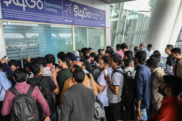 Passengers line up at an IndiGo Airlines kiosk at the Chennai International Airport in Chennai on December 5, 2025. Chaos gripped Indian airports on December 4 after the country's biggest airline IndiGo cancelled over 1,200 flights, stranding thousands of passengers. (Photo by R.Satish BABU / AFP)