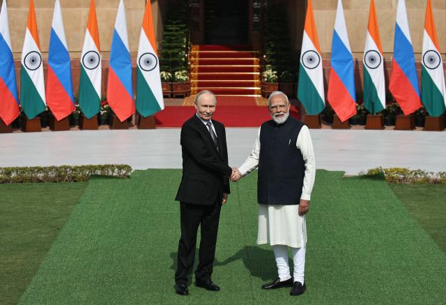 In this pool photograph distributed by the Russian state agency Sputnik, Russia's President Vladimir Putin shakes hands with India's Prime Minister Narendra Modi prior to their talks at the Hyderabad House in New Delhi on December 5, 2025. (Photo by Mikhail TERESHCHENKO / POOL / AFP) / ***Editor's note : this image is distributed by the Russian state owned agency Sputnik***