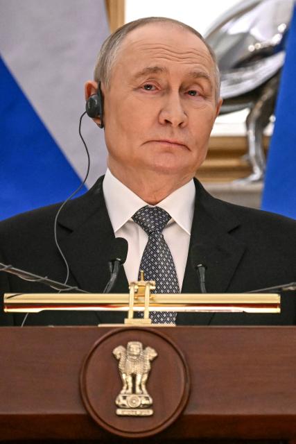 Russia's President Vladimir Putin listens as India's Prime Minister Narendra Modi speaks during the joint press statements after their meeting at the Hyderabad House in New Delhi on December 5, 2025. India's Prime Minister Narendra Modi hosted Russia's President Vladimir Putin on December 5, with defence and trade ties centre stage as New Delhi faces heavy US pressure to stop buying Moscow's oil. (Photo by Sajjad HUSSAIN / AFP)
