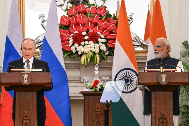 Russia's President Vladimir Putin (L) speaks as India's Prime Minister Narendra Modi listens during their joint press statements after their meeting at the Hyderabad House in New Delhi on December 5, 2025. India's Prime Minister Narendra Modi hosted Russia's President Vladimir Putin on December 5, with defence and trade ties centre stage as New Delhi faces heavy US pressure to stop buying Moscow's oil. (Photo by Sajjad HUSSAIN / AFP)