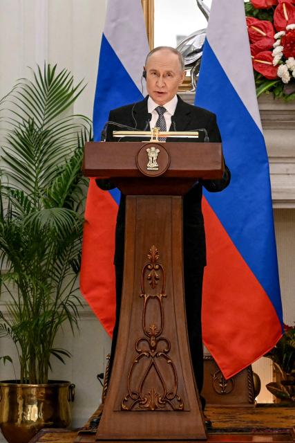Russia's President Vladimir Putin speaks during joint press statements with India's Prime Minister Narendra Modi after their meeting at the Hyderabad House in New Delhi on December 5, 2025. India's Prime Minister Narendra Modi hosted Russia's President Vladimir Putin on December 5, with defence and trade ties centre stage as New Delhi faces heavy US pressure to stop buying Moscow's oil. (Photo by Sajjad HUSSAIN / AFP)