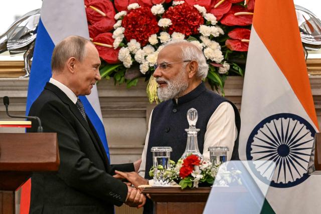 Russia's President Vladimir Putin (L) speaks with India's Prime Minister Narendra Modi after their joint press statements at the Hyderabad House in New Delhi on December 5, 2025. India's Prime Minister Narendra Modi hosted Russia's President Vladimir Putin on December 5, with defence and trade ties centre stage as New Delhi faces heavy US pressure to stop buying Moscow's oil. (Photo by Sajjad HUSSAIN / AFP)