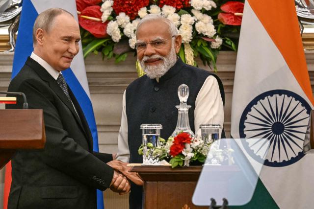 Russia's President Vladimir Putin (L) speaks with India's Prime Minister Narendra Modi after their joint press statements at the Hyderabad House in New Delhi on December 5, 2025. India's Prime Minister Narendra Modi hosted Russia's President Vladimir Putin on December 5, with defence and trade ties centre stage as New Delhi faces heavy US pressure to stop buying Moscow's oil. (Photo by Sajjad HUSSAIN / AFP)