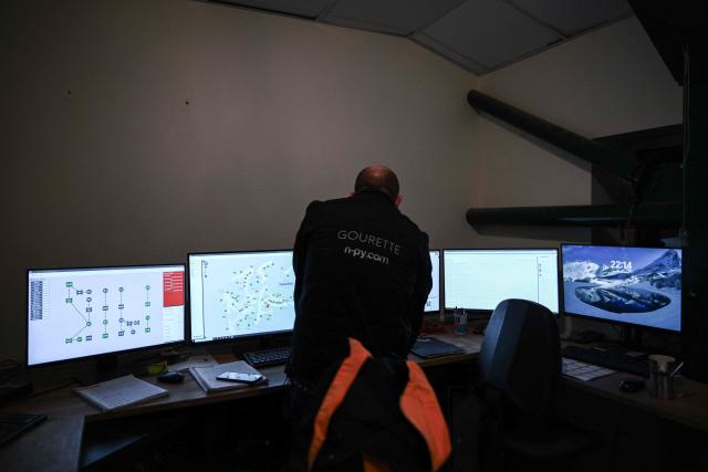A snowmaker monitors screens controlling the distribution of artificial snow through snow cannons at the Gourette ski resort near the Col d'Aubisque pass in the Pyrenees, south-western France on December 2, 2025. The family-oriented resort features one of the largest beginner areas in the Pyrenees and is a pioneer in the mountain range where skiing was first introduced in 1903 near Col d'Aubisque pass. (Photo by Philippe LOPEZ / AFP)