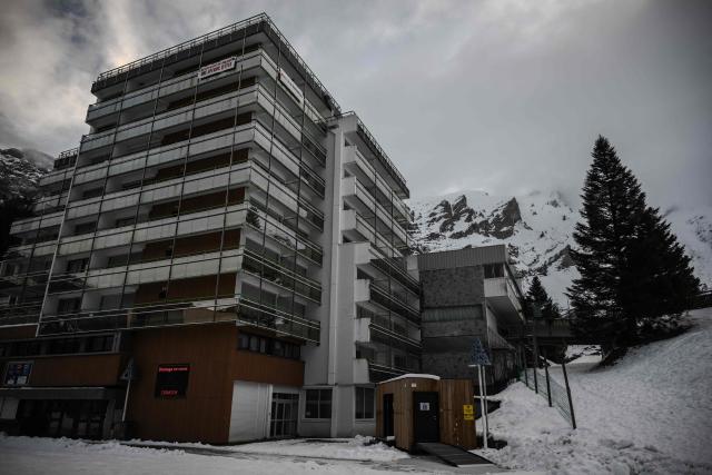 This photograph shows one of the main rental apartment buildings at the base of the slopes at the Gourette ski resort near the Col d'Aubisque pass in the Pyrenees, south-western France on December 3, 2025. The family-oriented resort features one of the largest beginner areas in the Pyrenees and is a pioneer in the mountain range where skiing was first introduced in 1903 near Col d'Aubisque pass. (Photo by Philippe LOPEZ / AFP)