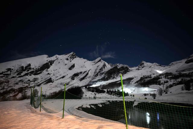 This photograph shows one of the two artificial reservoirs used to supply water for snowmaking operations at the Gourette ski resort near the Col d'Aubisque pass in the Pyrenees, south-western France on December 2, 2025. The family-oriented resort features one of the largest beginner areas in the Pyrenees and is a pioneer in the mountain range where skiing was first introduced in 1903 near Col d'Aubisque pass. (Photo by Philippe LOPEZ / AFP)