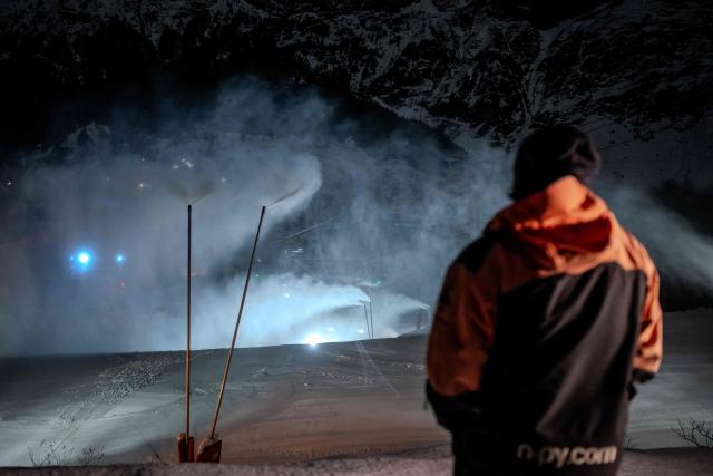 A snowmaker inspects the distribution of artificial snow through snow cannons at the Gourette ski resort near the Col d'Aubisque pass in the Pyrenees, south-western France on December 2, 2025. The family-oriented resort features one of the largest beginner areas in the Pyrenees and is a pioneer in the mountain range where skiing was first introduced in 1903 near Col d'Aubisque pass. (Photo by Philippe LOPEZ / AFP)