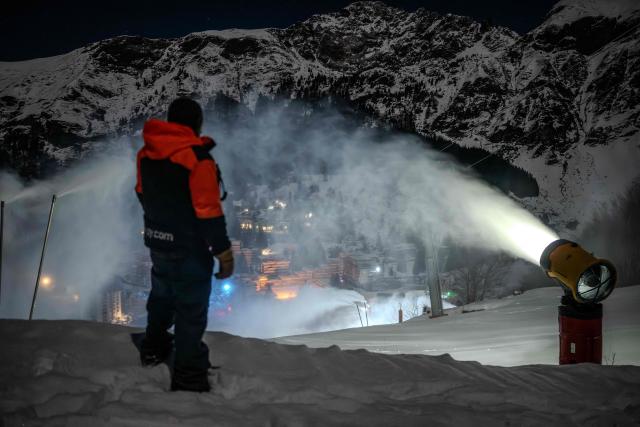 A snowmaker inspects the distribution of artificial snow through snow cannons at the Gourette ski resort near the Col d'Aubisque pass in the Pyrenees, south-western France on December 2, 2025. The family-oriented resort features one of the largest beginner areas in the Pyrenees and is a pioneer in the mountain range where skiing was first introduced in 1903 near Col d'Aubisque pass. (Photo by Philippe LOPEZ / AFP)