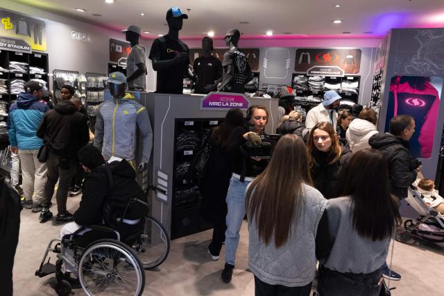 Customers walk through the pop-up store of French rapper Jul on the day of its opening in Marseille, southern France on June 7, 2024 (Photo by Miguel MEDINA / AFP)