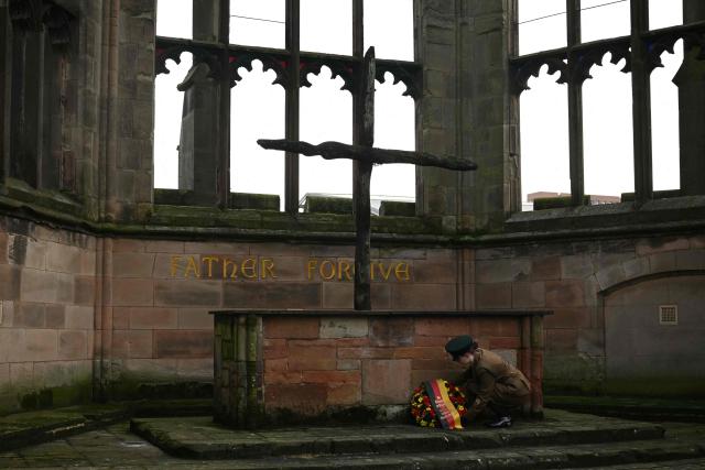 A cadet lays a floral wreath on behalf of The President in the ruins of the old Cathedral during a visit by President of the Federal Republic of Germany Frank-Walter Steinmeier to Coventry Cathedral in Coventry, central England on December 5, 2025, the final day of a three-day State visit to the UK by the German President. (Photo by Oli SCARFF / POOL / AFP)