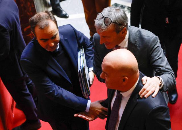 TOPSHOT - France's Prime Minister Sebastien Lecornu (L) and Les Democrates' MP Philippe Vigier leave after MPs adopted the "revenue" section during a voting session focused on the 2026 social security budget bill (PLFSS) at the National Assembly, the French Parliament lower house, in Paris on December 5, 2025. (Photo by Ian LANGSDON / AFP)