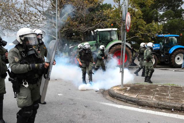Riot police officers use tear gas to disperse farmers blocking the road leading to the airport with their tractors during a protest over the reduced and delayed payment of European Union subsidies, in Thessaloniki on December 5, 2025. (Photo by AFP)