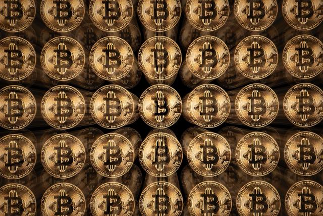 TOPSHOT - This illustration photograph shows a screen displaying Bitcoin logos, in Mulhouse on December 5, 2025. (Photo by SEBASTIEN BOZON / AFP)