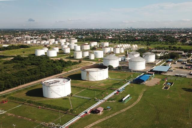 Aerial view of the Guillermo Elder Bell refinery of Bolivian state-owned oil company YPFB in Santa Cruz, Bolivia, on December 5, 2025. On Tuesday, Bolivia's new centre-right government denounced the misappropriation of millions of dollars worth of fuel under previous administrations of the Movement Towards Socialism (MAS) party, which even impacted the country during the recent fuel shortage crisis. This week, the public prosecutor's office raided the state oil company YPFB and the National Hydrocarbons Agency, which are under investigation for alleged corruption. (Photo by Rodrigo URZAGASTI / AFP)